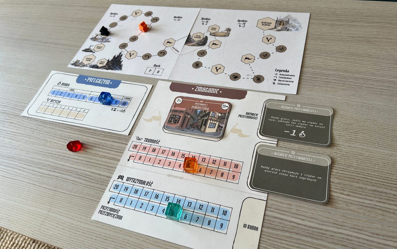Pilgrim route board, Faith and decision track, Struggle board, cards, dice, and coloured markers set up for play.