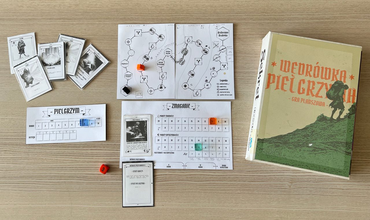 Earlier black-and-white Pilgrim prototype with a hand-drawn route map, cards, tracking boards, dice, and a game box.