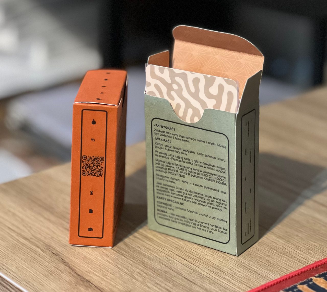 Orange and green handmade ToeShamBo boxes, with one open to reveal the patterned card backs.